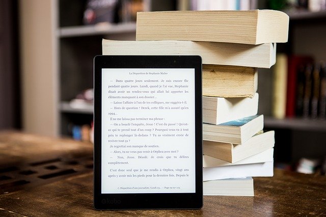 Stack of books with a tablet