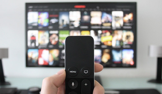 a picture of a remote pointing to a tv