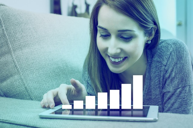 Woman sitting on couch with tablet